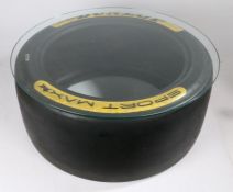 Dunlop touring car slick tyre coffee table. 66cm diameter, 30cm height with glass top.