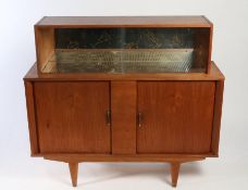 A mid-century Teak cocktail cabinet. The top section with sliding glass with a mirrored interior,