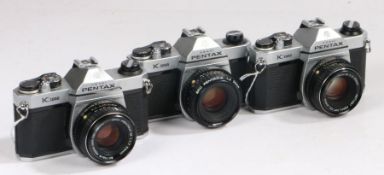 Three Pentax K1000 cameras all with 50mm lenes (3)
