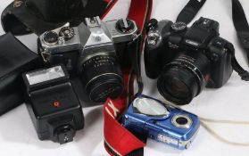 Three cameras to include Pentax Asahi 5212538, Canon Powershot SX10IS, Olympus digital camera, and a