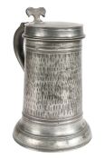 A rare William & Mary pewter Beefeater flagon, circa 1700 The straight-sided drum hammered all-over,