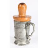 A George III pewter half-pint mug, with lignum vitae re-former or reformer, circa 1800 The footed
