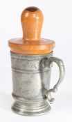 A George III pewter half-pint mug, with lignum vitae re-former or reformer, circa 1800 The footed