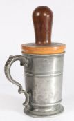 A George III pewter quart mug with impressive lignum vitae re-former or jack, circa 1800 The