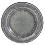 An early 18th century small pewter plate, English, circa 1700-20 The single reeded rim engraved with