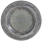 An early 18th century small pewter plate, English, circa 1700-20 The single reeded rim engraved with