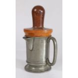 A Victorian pewter spouted pint measure, with lignum vitae re-former or jack, circa 1880 The plain