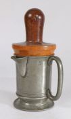 A Victorian pewter spouted pint measure, with lignum vitae re-former or jack, circa 1880 The plain