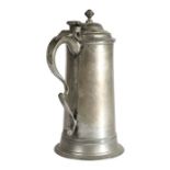 A George I pewter spire flagon, circa 1715 Having a plain straight-sided gently tapering drum, a