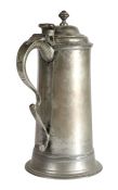 A George I pewter spire flagon, circa 1715 Having a plain straight-sided gently tapering drum, a
