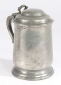 An early 19th century pewter pint tulip-shaped domed-lidded tankard, English, circa 1825 Having a
