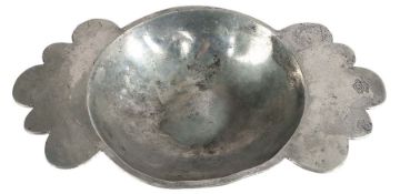 A rare Henry VIII pewter twin-handled porringer, circa 1540 Having a curved bowl, bossed base, and