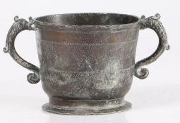 An exceptional and rare Charles II pewter twin-handle cup, circa 1670 The body with reeded rim and