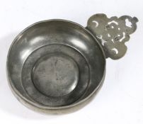 A William & Mary pewter porringer, circa 1695 Having a bellied bowl, bossed base and relief cast
