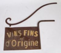 A wrought iron vineyard sign with bracket, circa 1920, the rectangular sign inscribed "VINS FINS d'