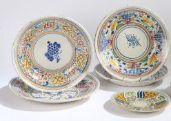 A collection of seven Spanish porcelain dishes, all with polychrome stylised foliate and fruit