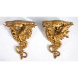 A good pair of George III carved giltwood wall brackets, the serpentine fronted tops above