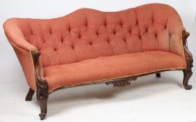 A Victorian rosewood and upholstered three seater settee, with a wavy buttoned back above scroll