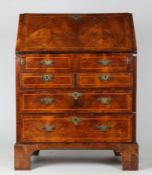 A George III walnut bureau with cross banding and boxwood inlaid, with a sloping fall opening to