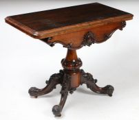 A Victorian rosewood card table, the rectangular top opening to reveal a circular green baize