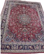 A Tabriz carpet, central light blue floral medallion on red field, light blue spandrels, with all-