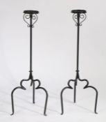 Pair of 19th Century iron candlestands, France circa 1860, the scrolled basket tops above plain