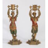 A Pair of polychrome painted spelter candlesticks, with swinging sconces, depicting far eastern