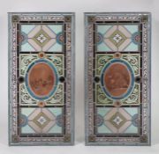 A Pair of 19th Century polychrome stained glass panels, the oval central panels decorated with