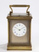 A good late 19th Century French brass carriage clock, of large proportions, with a five bevelled