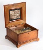 A Victorian mahogany and marquetry inlaid Polyphon, the hinged lid with interior print depicting