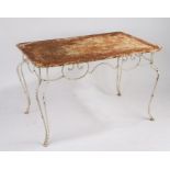 A French iron garden table, circa 1920, the pierced rectangular top above a scrolled frieze,