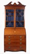 A George III mahogany and marquetry inlaid bureau-bookcase, the broken arch pediment with shell