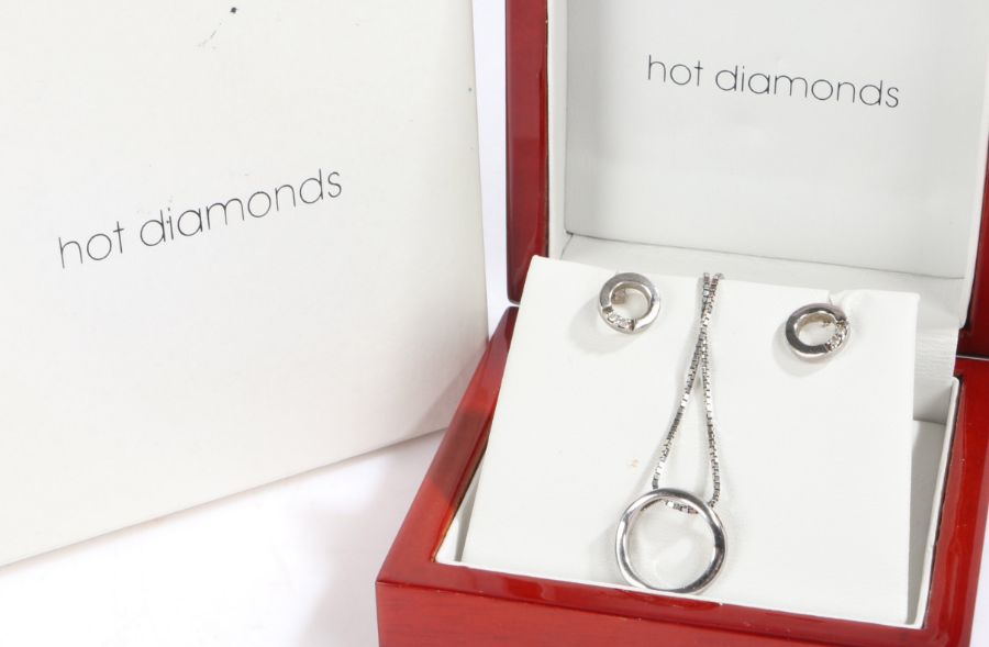 Suit of Diamond and silver jewellery, to include a pair of earrings and a necklace and pendant,