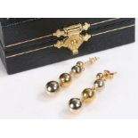 Pair of 18 carat gold drop earrings, decorated with graduating spheres, stamped 750, weight 2.2