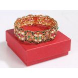 Gem set yellow metal bangle, the bangle set with various stones to include pearls etc, 7cm diameter