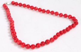 Red spherical beaded necklace, formed of spherical beads on a white metal clasp