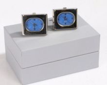 Pair of watch cuff-links, the cuff-links set with a blue oval dial and Roman numerals housed