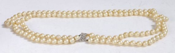 Pearl two strand necklace, with two rows of circular beads and a white metal clasp, 59cm long