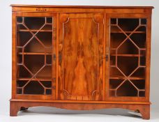 Reproduction yew wood glazed cabinet, having a pair of astragal glazed doors flanking a central