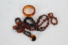 A Collection of Bakelite style items, to include bangle and three necklaces (4)