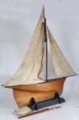 A good pond yacht, the single mast with three sails,  the wooden hull with metal base to the keel,
