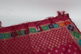 An silk brocade Deli shawl, the pink ground set with gilt accents, 228cm long