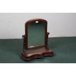 Victorian mahogany toilet mirror, with an arched mirror with scroll supports and a serpentine