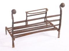 A cast iron fire grate, with orb finials, four bar front and detachable bracket, 68cm wide, 40cm