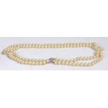 Pearl two strand necklace, with two rows of circular beads and a white metal clasp, 59cm long