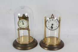 Two Brass anniversary clocks, both with glass domes, largest 32cm high