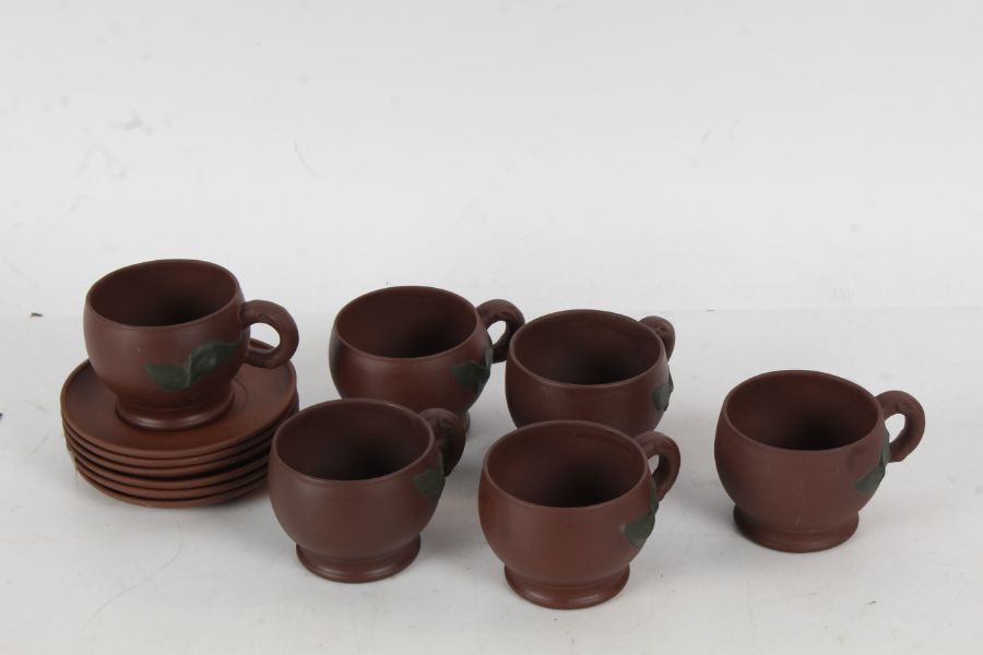 A 20th century Chinese pottery tea set, the brown pottery tea set decorated with a leaf, six saucers