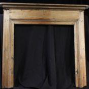 19th/20th century pine fire surround, the rectangular top above moulded supports, 124cm high