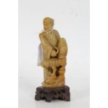 Chinese carved soapstone figure, of a gentleman and dog of foo, 15.5cm tall