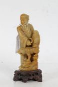 Chinese carved soapstone figure, of a gentleman and dog of foo, 15.5cm tall